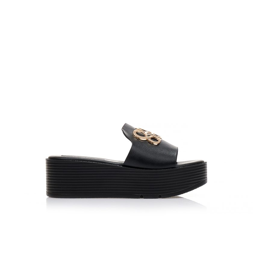 Flatforms μαύρα δερματίνη με χρυσή μεταλλική αγκράφα στη φάσα ΜΑΥΡΟ